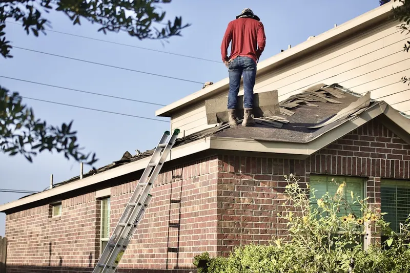 Professional roofer working on a residential roof in Merwinsville